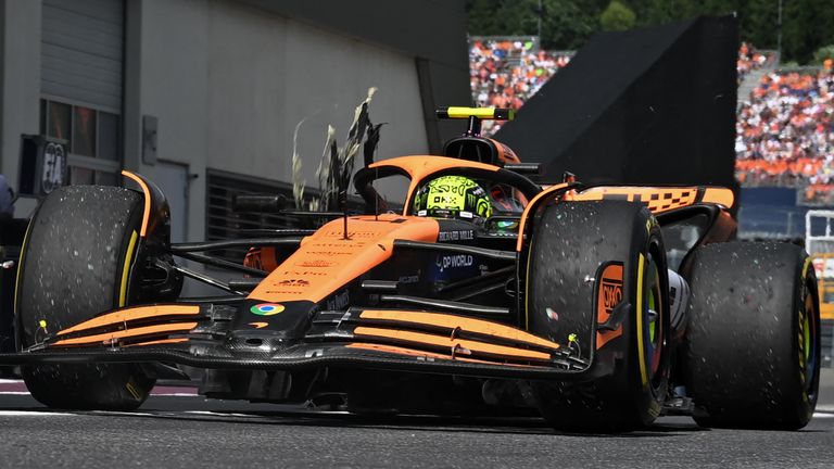 McLaren's British driver Lando Norris arrives to stop with a damaged rear tyre in the pits during the Formula One Austrian Grand Prix on the Red Bull Ring race track in Spielberg, Austria, on June 30, 2024. (Photo by CHRISTIAN BRUNA / POOL / AFP)