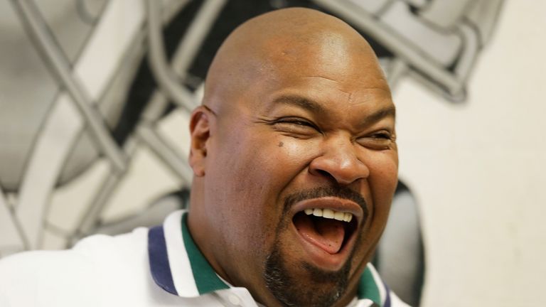 Dallas Cowboys Hall of Famer Larry Allen smiles while watching his son and the varsity football team lift weights at De La Salle high school Tuesday, July 30, 2013, in Concord, Calif. After 12 dominant seasons and a Super Bowl title with the Cowboys and two final years closer to home with San Francisco, his Pro Football Hall of Fame enshrinement speech Saturday night