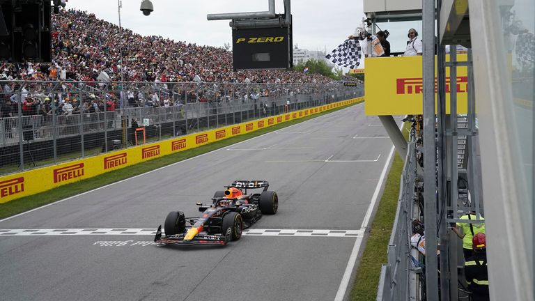 Red Bull Racing's Max Verstappen, of the Netherlands, takes the chequered flag to win the Formula One Canadian Grand Prix auto race Sunday, July 18, 2023, in Montreal. (Timothy A. Clary/Pool Photo via AP)
