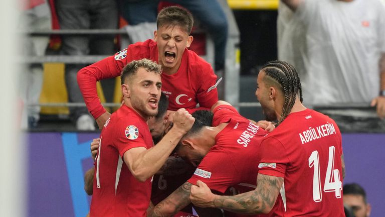Turkey's Mert Muldur celebrates with teammates after scoring his team's first goal during the Group F match between Turkey and Georgia at the Euro 2024 soccer tournament in Dortmund, Germany, Tuesday, June 18, 2024. (AP Photo/Martin Meissner )