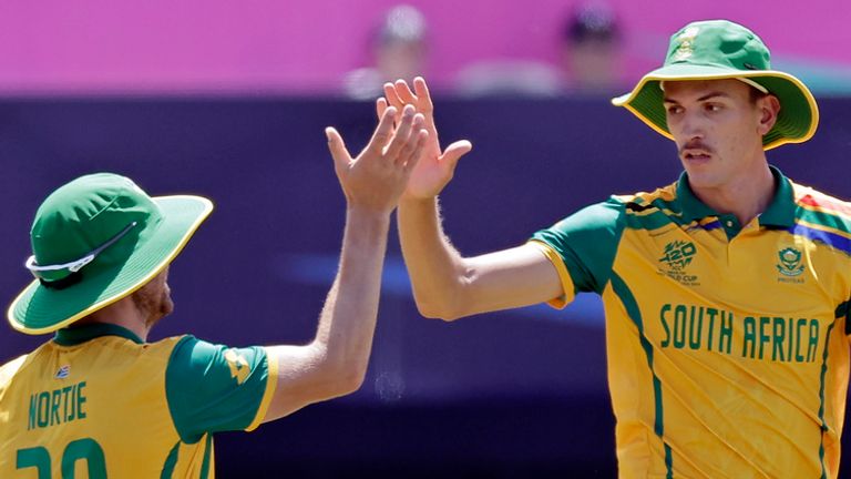 South Africa's Marco Jansen is high-fived by Anrich Nortje after catching an out for a wicket on Sybrand Engelbrecht of the Netherlands during an ICC Men's T20 World Cup cricket match at the Nassau County International Cricket Stadium in Westbury, New York, Saturday, June 8, 2024. (AP Photo/Adam Hunger)