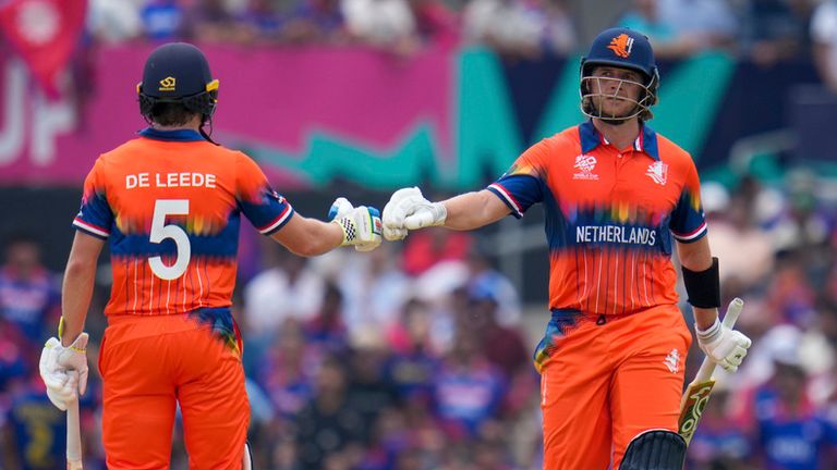 Netherlands' Max O'Dowd, right, bumps gloves with teammate Bas de Leede during their partnership against Nepal at an ICC Men's T20 World Cup cricket match at Grand Prairie Stadium in Grand Prairie, Texas, Tuesday, June 4, 2024. (AP Photo/Julio Cortez)