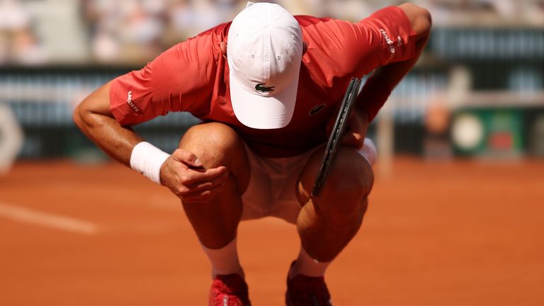 Novak Djokovic of Sebia rubs his knee on his way to defeating Francisco Cerundolo of Argentina in their fourth round match during day nine of the 2024 French Open at Roland Garros on June 03, 2024 in Paris, France. (Photo by Ian MacNicol/Getty Images)