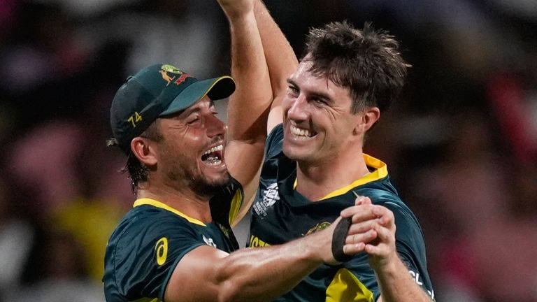 Australia's Pat Cummins, right, is greeted by teammates Marcus Stoinis and Tim David, left, during the men's T20 World Cup cricket match between Afghanistan and Australia at the Arnos Vale Ground, Kingstown, Saint Vincent and the Grenadines, Saturday, June 22, 2024. ( AP Photo/Ramon Espinosa)