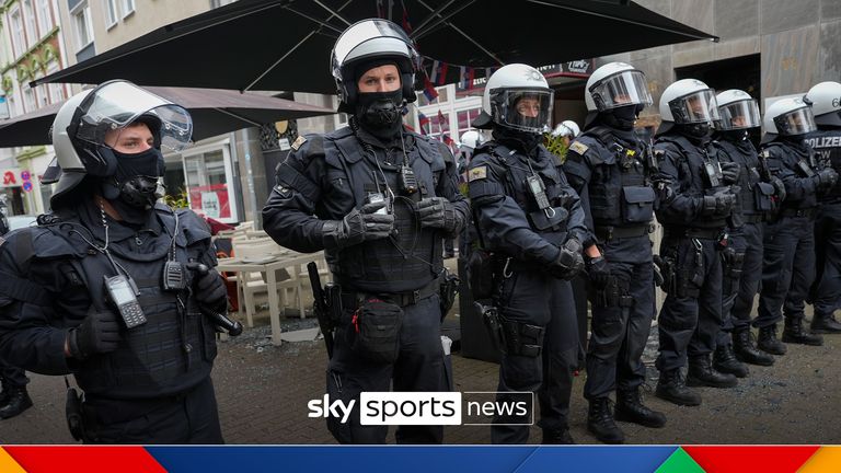 Riot police stand guard on the street ahead the Group C match between Serbia and England