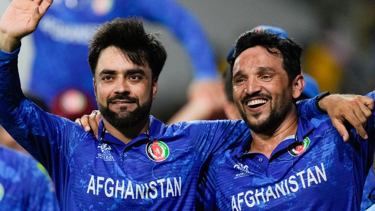 Afghanistan captain Rashid Khan, left, and teammate Gulbadin Naib celebrate after defeating Bangladesh by eight runs in the men's T20 Cricket World Cup match at Arnos Vale Ground, Kingstown, St. Vincent and the Grenadines, Monday, June 24, 2024 (AP Photo/ Ricardo Mazalan)