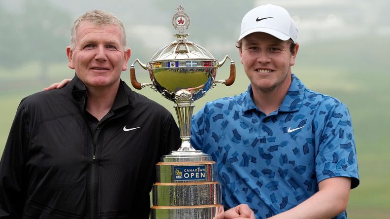 Scotland's Robert MacIntyre, right, and his father and caddie, Dougie MacIntyre, left, pose for photos with the championship trophy after Robert won the Canadian Open golf tournament in Hamilton, Ontario, Sunday, June 2, 2024. (Frank Gunn/The Canadian Press via AP)