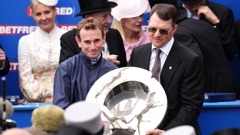 Jockey Ryan Moore and trainer Aidan O'Brien with the trophy after City Of Troy's Derby success