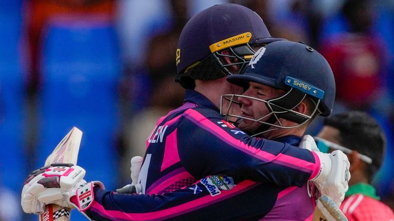 Scotland's Matthew Cross and Brandon McMullen celebrate Scotland's seven-wicket win over Oman in Antigua (Associated Press)