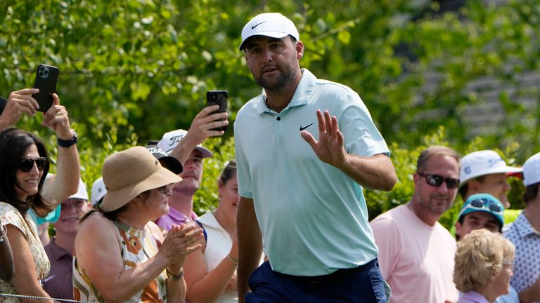 Scottie Scheffler acknowledges the crowd on the first tee during the first round of the Travelers Championship golf tournament at TPC River Highlands, Thursday, June 20, 2024, in Cromwell, Conn. (AP Photo/Seth Wenig)