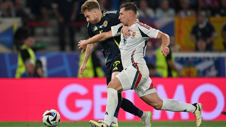 STUTTGART, GERMANY - JUNE 23: Stuart Armstrong of Scotland is challenged by Willi Orban of Hungary in the penalty area during the UEFA EURO 2024 group stage match between Scotland and Hungary at Stuttgart Arena on June 23, 2024 in Stuttgart, Germany. (Photo by Chris Ricco - UEFA/UEFA via Getty Images)