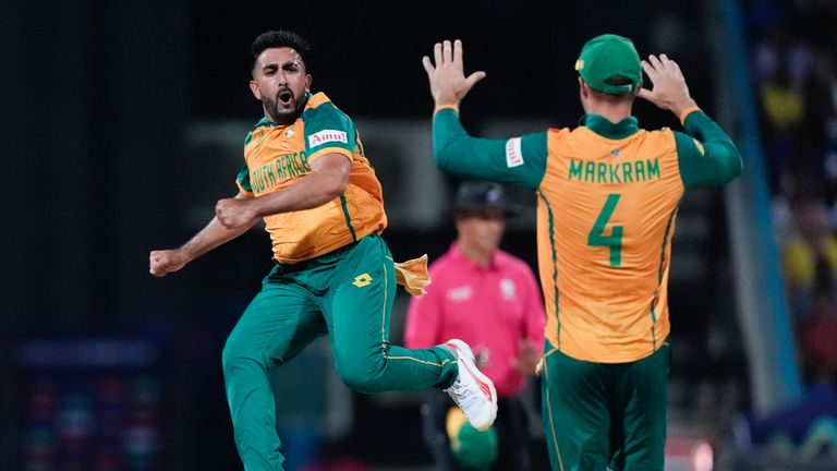 Tabraiz Shamsi of South Africa celebrates with teammate Aiden Markram after taking the wicket of Sherfan Rutherford of West Indies during the ICC Men's Cricket World Cup T20 match between West Indies and South Africa at the Sir Vivian Richards Stadium in North Sound, Antigua and Barbuda, on Sunday, June 23, 2024. (AP Photo/Lynne Sladky)