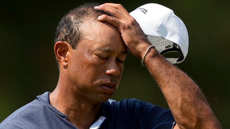 Tiger Woods wipes his face on the 10th hole during a weather warning during the second round of the U.S. Open golf tournament, Friday, June 14, 2024, in Pinehurst, NC (AP Photo/Matt York)