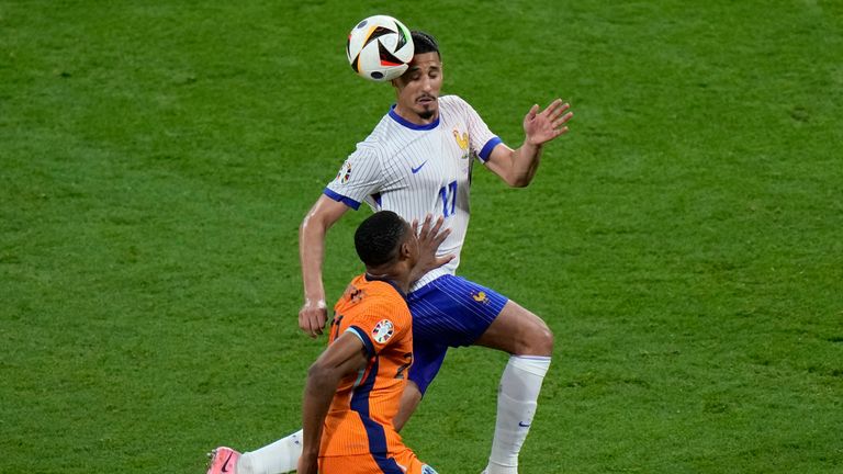 William Saliba of France heads the ball as Denzel Dumfries of the Netherlands pushes him during a Group D match between the Netherlands and France at the Euro 2024 soccer tournament in Leipzig, Germany, Friday, June 21, 2024. (AP Photo/Sergei Grits)