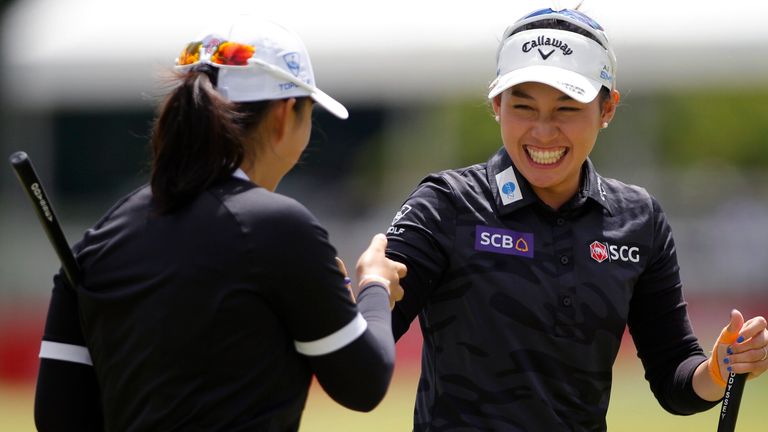 Atthaya Thitikul, of Thailand, right, and partner Ruoning Yin, of China, celebrate after a birdie on the 18th hole during the final round of the Dow Championship LPGA golf tournament, Sunday, June 30, 2024, at Midland Country Club in Midland, Mich. (AP Photo/Al Goldis)