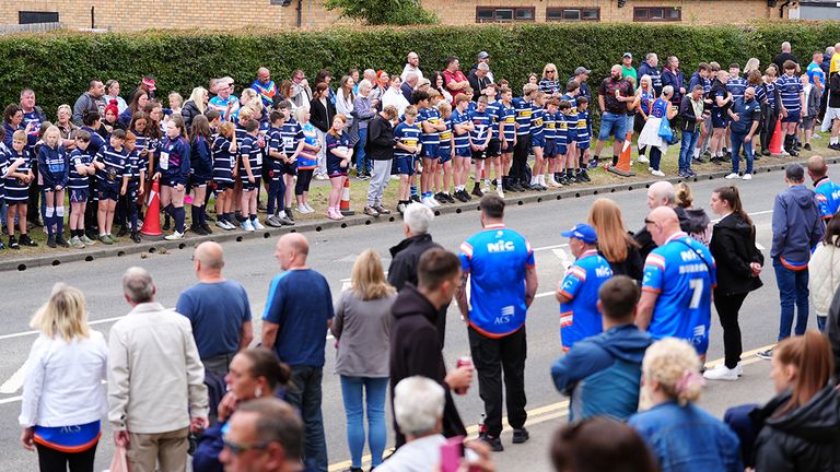 Mourners and members of Featherstone Lions gather before the funeral for former Leeds Rhinos player Rob Burrow (PA Images)