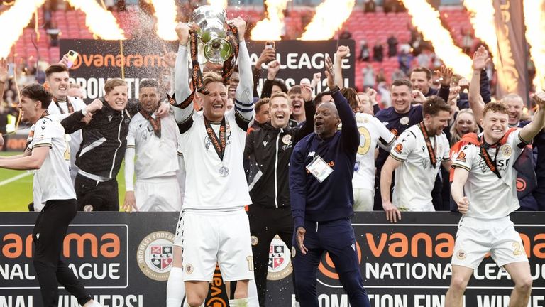 Byron Webster lifts the National League play-off final trophy after Bromley's win at Wembley