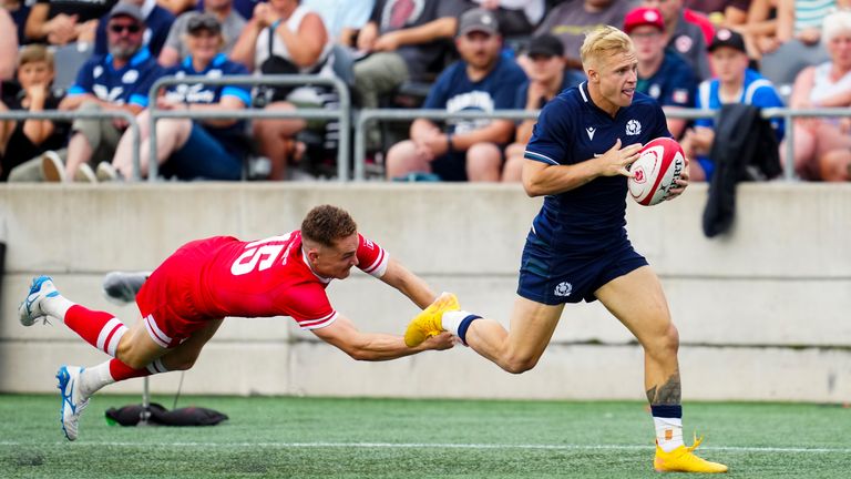 Canada's Cooper Coats (15) dives for Scotland's Arron Reed, right, who makes his way to score a try during the second half of men's rugby match action in Ottawa, Ontario, Saturday, July 6, 2024.. (Sean Kilpatrick/The Canadian Press via AP)