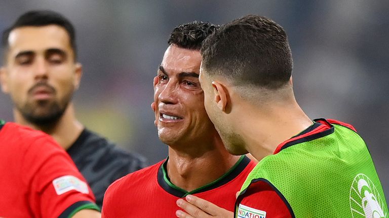 Cristiano Ronaldo was consoled by team-mates after seeing an extra-time penalty saved against Slovakia