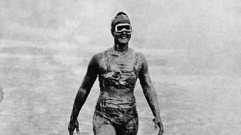 Gertrude Ederle enters the water with body greased and wearing goggles for the start of her record-breaking swim across the English Channel. 