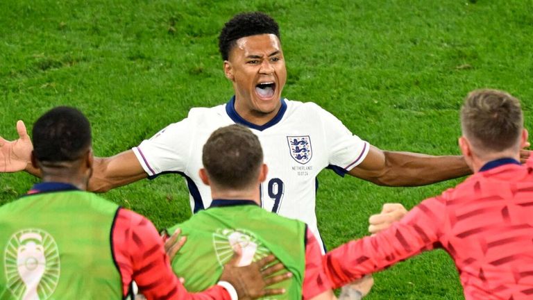 Ollie Watkins celebrates his late winner with the England substitutes