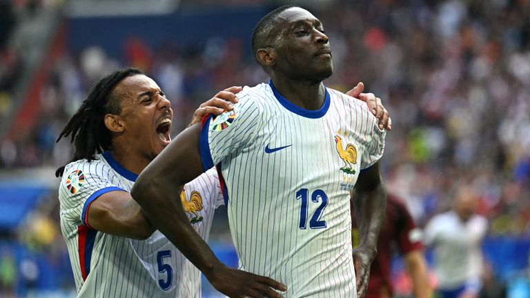 France's forward #12 Randal Kolo Muani (R) celebrates with France's defender #05 Jules Kounde scoring his team's first goal during the UEFA Euro 2024 round of 16 football match between France and Belgium at the Duesseldorf Arena in Duesseldorf on July 1, 2024. (Photo by OZAN KOSE / AFP)