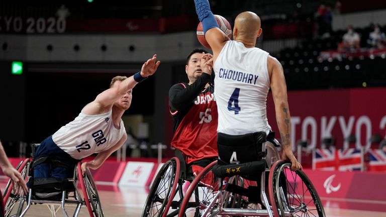 Britain's Gaz Choudhry (4) blocks a shot by Japan...s Hiroaki Kozai (55) during a men...s wheelchair basketball semifinal game at the Tokyo 2020 Paralympic Games, Friday, Sept. 3, 2021, in Tokyo, Japan. (AP Photo/Kiichiro Sato)