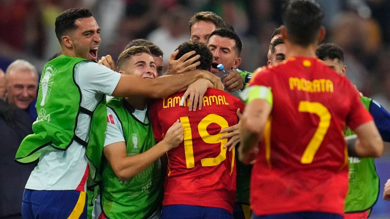 Spain's Lamine Yamal celebrates with his teammate after scoring his side's first goal during a semifinal match between Spain and France at the Euro 2024 soccer tournament in Munich, Germany, Tuesday, July 9, 2024. (AP Photo/Manu Fernandez)