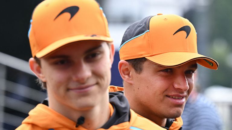 McLaren's Australian driver Oscar Piastri (L) and McLaren's British driver Lando Norris look on as they walk in the paddock ahead of the Formula One Belgian Grand Prix at the Spa-Francorchamps circuit in Spa on July 26, 2024 (Photo by JOHN THYS / AFP)