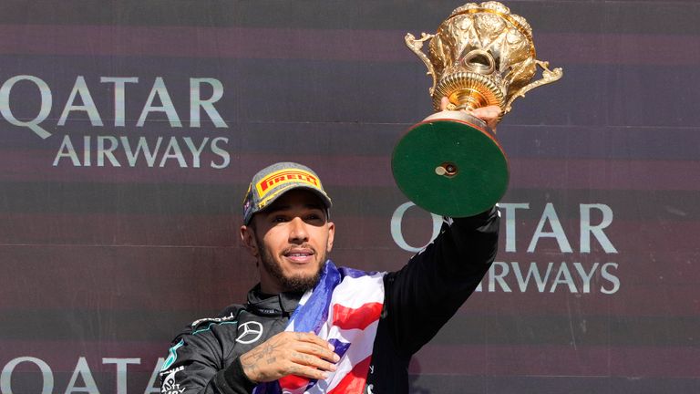 Mercedes driver Lewis Hamilton of Britain celebrates on the podium after winning the British Formula One Grand Prix race at the Silverstone racetrack, Silverstone, England, Sunday, July 7, 2024. (AP Photo/Luca Bruno)