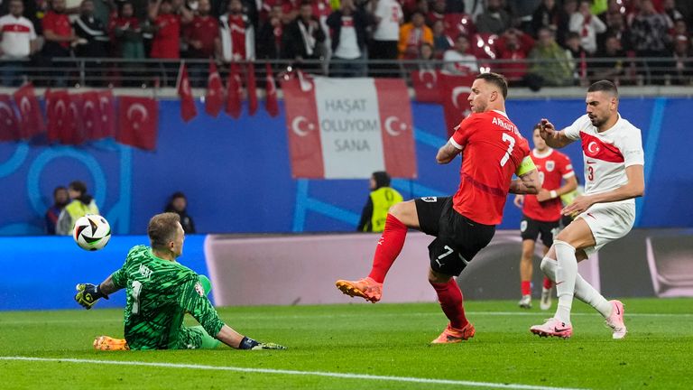 Austria's Marko Arnautovic (center) shoots against Turkey's goalkeeper Mert Gunoc (left) during the round of 16 match between Austria and Turkey at the Euro 2024 soccer tournament in Leipzig, Germany, Tuesday, July 2, 2024. (AP Photo/ Martin Meissner)