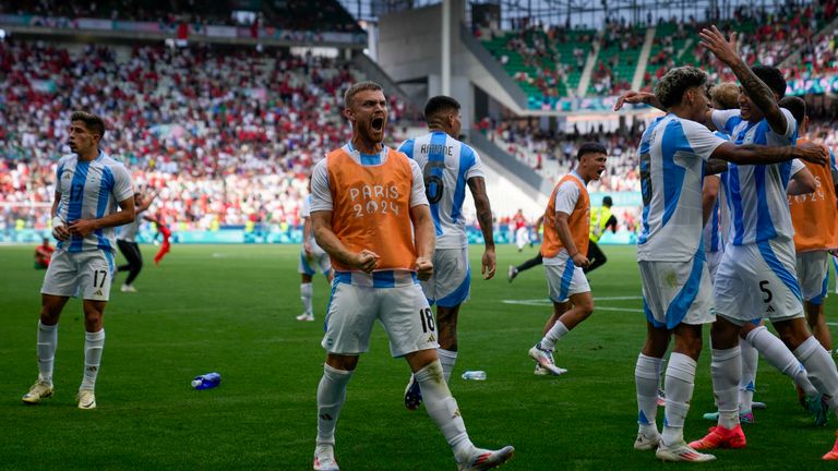 Argentina's players celebrate their side's second goal scored by Cristian Medina during the men's Group B soccer match between Argentina and Morocco at Geoffroy-Guichard Stadium at the 2024 Summer Olympics, Wednesday, July 24, 2024, in Saint-Etienne, France. (AP Photo/Silvia Izquierdo)