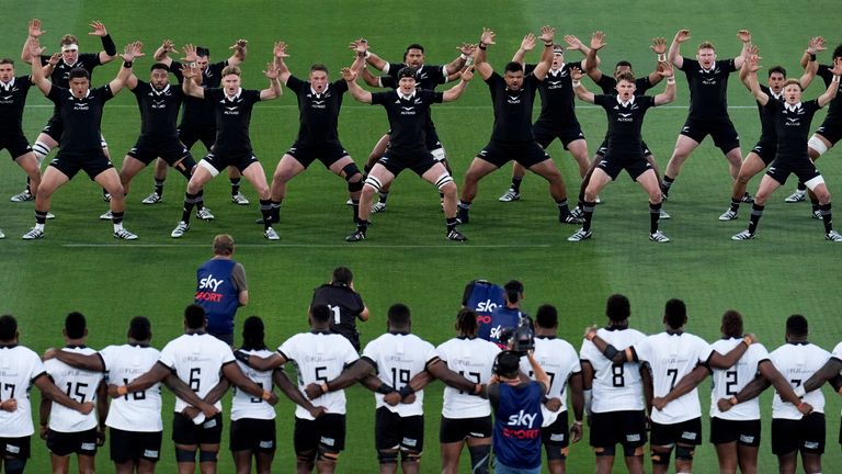 New Zealand's players perform the haka as players for Fiji look on in San Diego. (AP Photo/Gregory Bull)