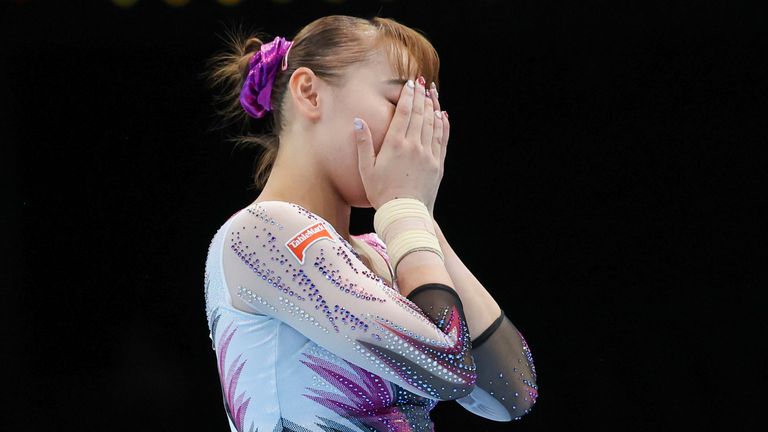 Japan's Shoko Miyata reacts after falling on the floor exercise during the women's team final at the Artistic Gymnastics World Championships in Antwerp, Belgium, Wednesday, Oct. 4, 2023. (AP Photo/Geert vanden Wijngaert)