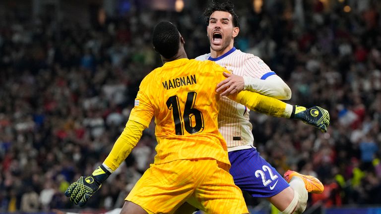 Theo Hernandez of France, right, celebrates with goalkeeper Mike Maignan after scores the winning goal to defeat Portugal during a quarter final match at the Euro 2024 soccer tournament in Hamburg, Germany, Friday, July 5, 2024. (AP Photo/Hassan Ammar)