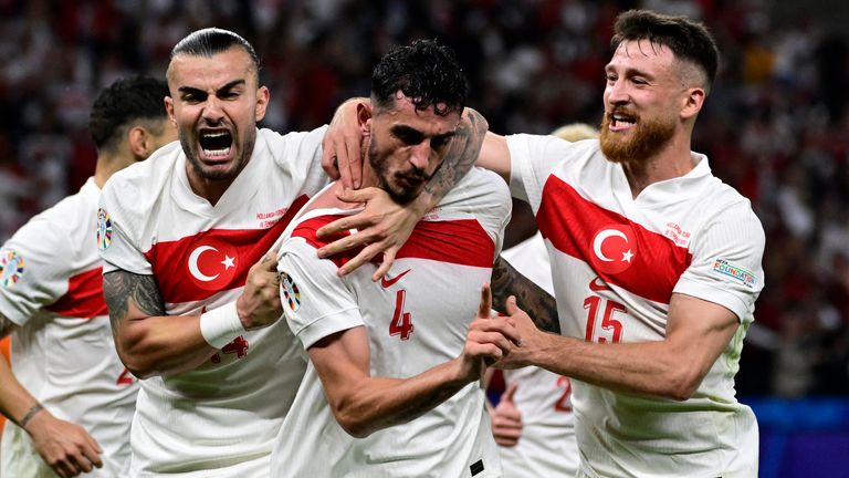 Turkey's defender #04 Samet Akaydin celebrates scoring the opening goal with his teammates during the UEFA Euro 2024 quarter-final football match between the Netherlands and Turkey at the Olympiastadion in Berlin on July 6, 2024. (Photo by JOHN MACDOUGALL / AFP)