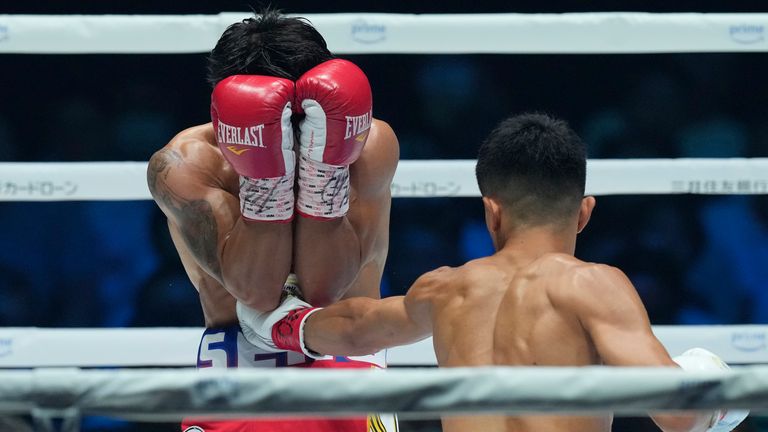 Filipino challenger Vincent Astrolabio, left, gets a punch to be knocked down by Japanese champion Junto Nakatani during the first round of their WBC bantamweight world title boxing match in Tokyo, Saturday, July 20, 2024. (AP Photo/Hiro Komae)