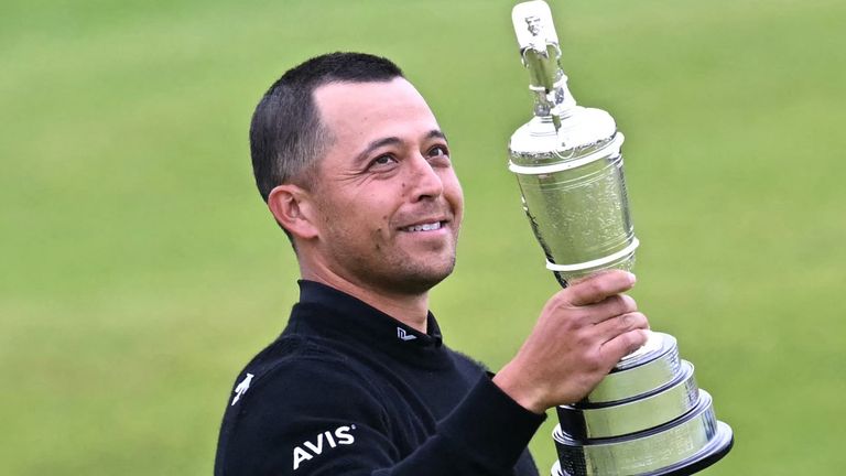 US golfer Xander Schauffele poses with the Claret Jug, the trophy for the Champion golfer of the year after winning the 152nd British Open Golf Championship at Royal Troon on the south west coast of Scotland on July 21, 2024. (Photo by Paul ELLIS / AFP) / RESTRICTED TO EDITORIAL USE