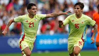 Spain's Sergio Camello, left, celebrates scoring his country's fourth goal in the Olympic final