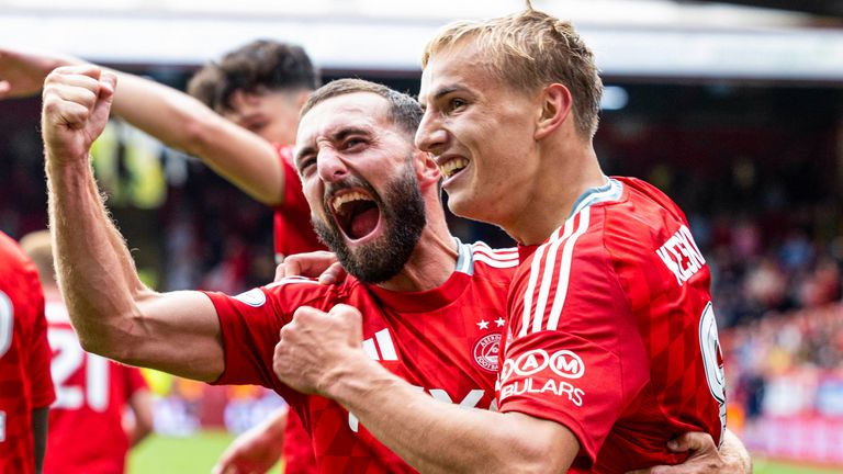 ABERDEEN, SCOTLAND - AUGUST 17: Aberdeen's Topi Keskinen celebrates with Graeme Shinnie as he scores to make it 1-0 during a Premier Sports Cup last sixteen match between Aberdeen and Queen's Park at Pittodrie Stadium, on August 17, 2024, in Aberdeen, Scotland.  (Photo by Ross Parker / SNS Group)