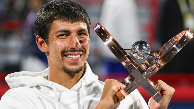 Alexei Popyrin, of Australia, holds up the winner's trophy after defeating Andrey Rublev, of Russia, in the final of the National Bank Open men's tennis tournament in Montreal, Monday, Aug. 12, 2024. (Graham Hughes/The Canadian Press via AP)