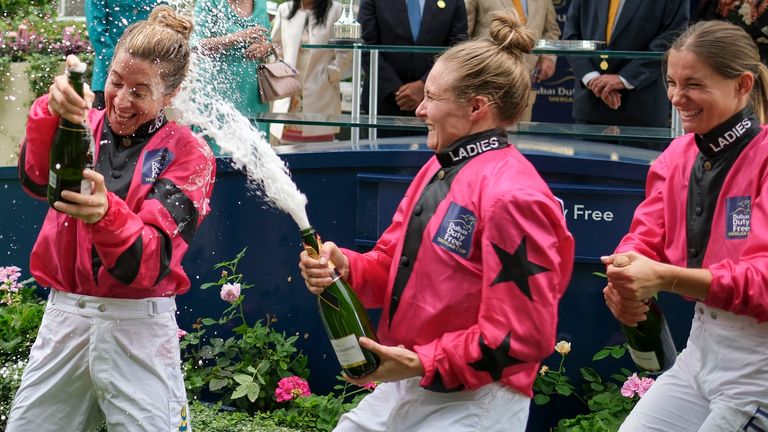 Hayley Turner (L) celebrates the 'Ladies' team winning The Dubai Duty Free Shergar Cup with Joanna Mason (C) and Marie Velon