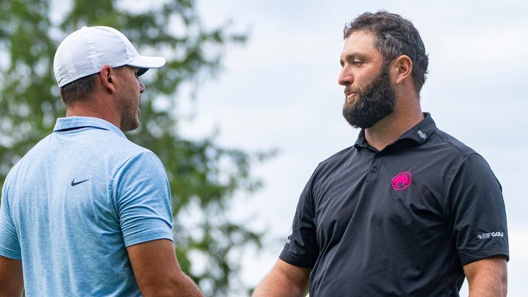 Captain Brooks Koepka, left, of Smash GC, shakes hands with captain Jon Rahm, of Legion XIII, on the 18th green during the final round of LIV Golf Greenbrier at The Old White at The Greenbrier, Sunday, Aug.  18, 2024, in White Sulphur Springs, W.Va. (Mike Stobe/LIV Golf via AP) 