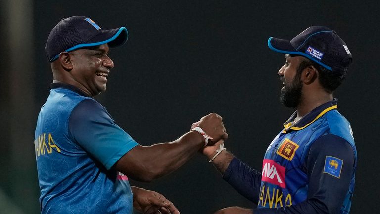 Sri Lanka's captain Charith Asalanka (R) and coach Sanath Jayasuriya (L) celebrate their win over India in the third ODI