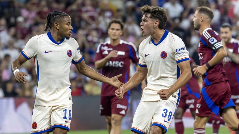 Chelsea's Christopher Nkunku, left, celebrates scoring with teammate Marc Guiu during the Europa Conference League play-offs round second leg soccer match between Switzerland's Servette FC and England's Chelsea FC, at the Stade de Geneve stadium, in Geneva, Switzerland, Thursday, Aug. 29, 2024. (Laurent Gillieron/Keystone via AP)