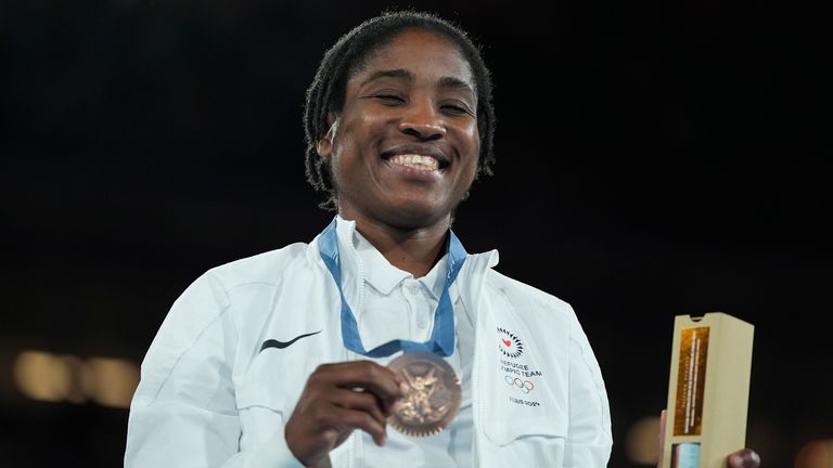 Bronze medalist Refugee Olympic Team's Cindy Ngamba poses during a medals ceremony for the women's 75 kg final boxing match at the 2024 Summer Olympics, Saturday, Aug. 10, 2024, in Paris, France. (AP Photo/John Locher)