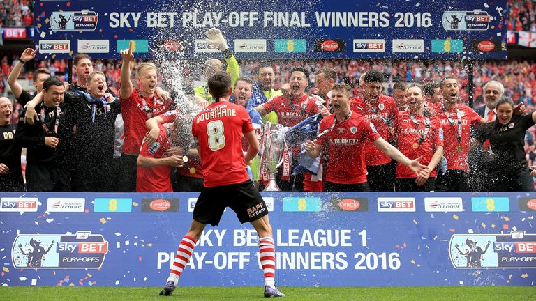 Barnsley's Conor Hourihane sprays champagne over his team-mates during their celebrations during the Sky Bet League One Play-Off Final at Wembley in 2016