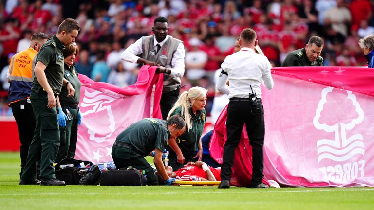 Covers are placed around Danilo as he receives treatment for an injury