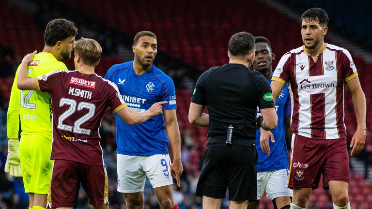 GLASGOW, SCOTLAND - AUGUST 17: Rangers' Cyriel Dessers pleads his innocence before a VAR check confirms his goal to make it 1-0 following a potential foul on St Johnstone's Jack Sanders (R) during a Premier Sports Cup last sixteen match between Rangers and St Johnstone at Hampden Park, on August 17, 2024, in Glasgow, Scotland. (Photo by Craig Williamson / SNS Group)