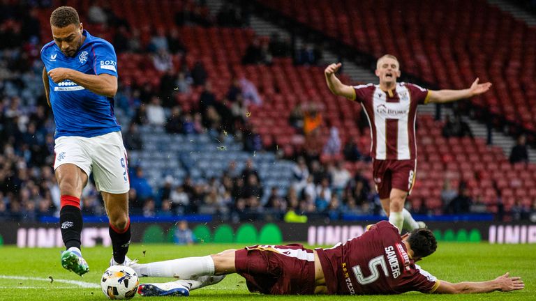 GLASGOW, SCOTLAND - AUGUST 17: Rangers' Cyriel Dessers collides with St Johnstone's Jack Sanders before he scores to make it 1-0 during a Premier Sports Cup last sixteen match between Rangers and St Johnstone at Hampden Park, on August 17, 2024, in Glasgow, Scotland.  (Photo by Craig Williamson / SNS Group)